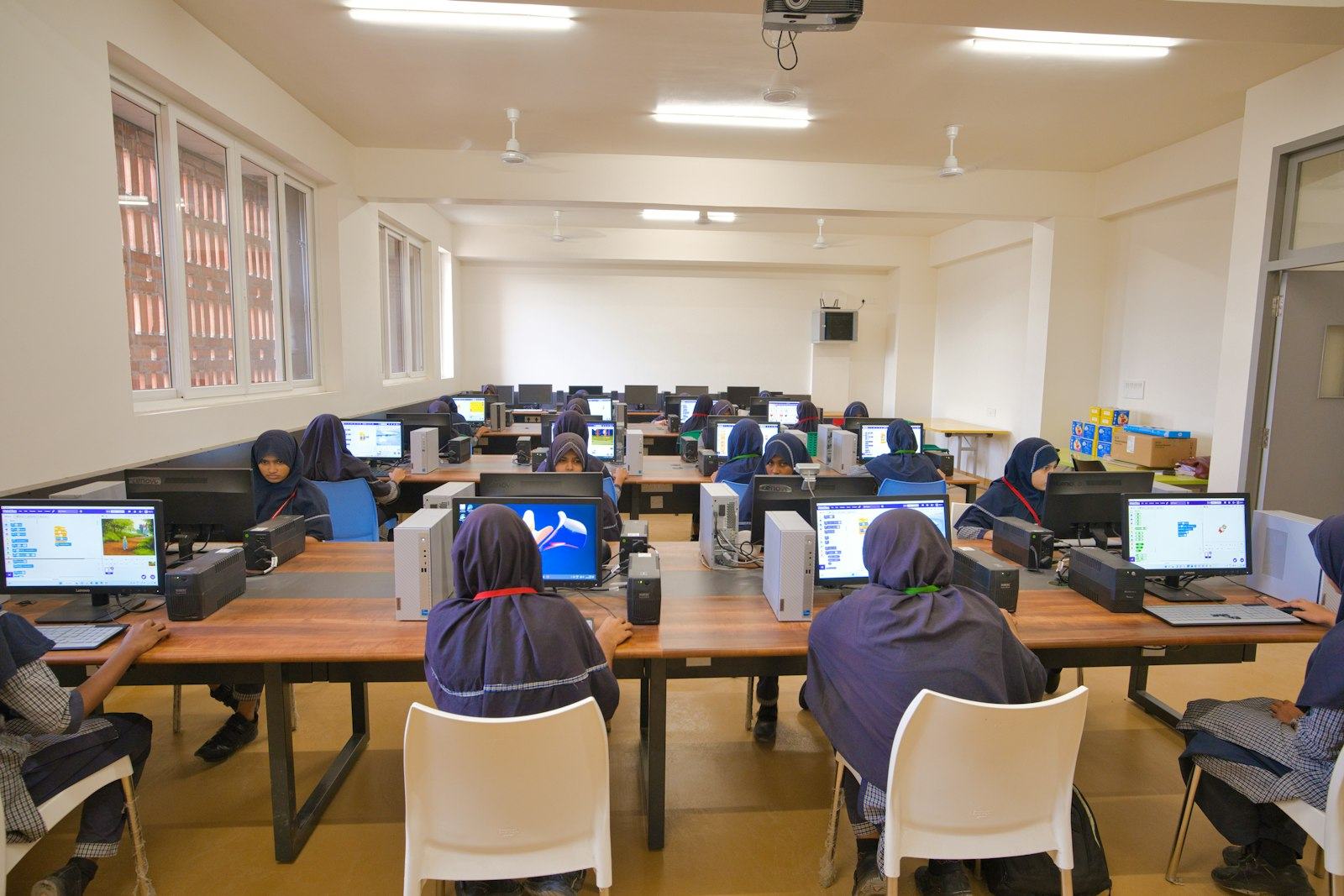 People working at computers in a computer room
