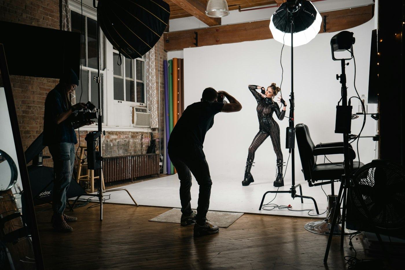 A photographer shooting a model in a studio