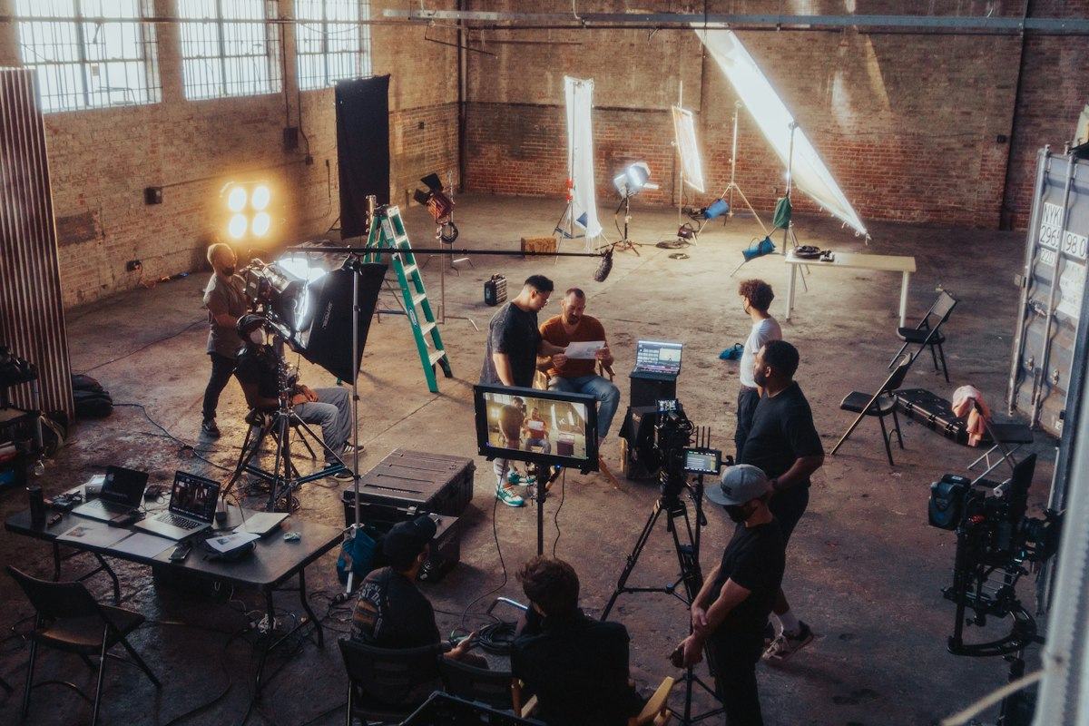 A film crew setting up a camera on set